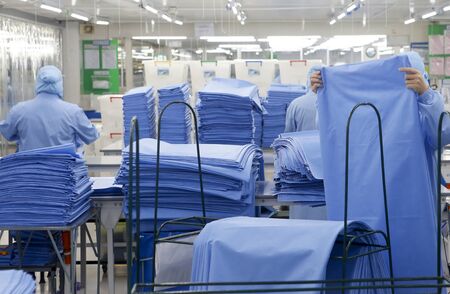 Factory workers are producing Personal Protective Equipment (PPE)
for protection against viruses corona (Covid-19). For medical use.の写真素材