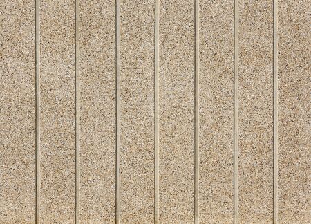 Pebbles Small stones on concrete wall. Color stone in background.