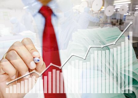 Male hands draw a graph showing the increasing demand for medical masks.Concept