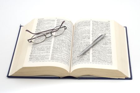 open dictionary with glasses and penの写真素材