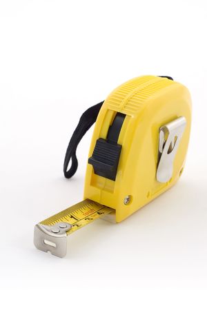 A yellow retractable tape measure on a white backgroundの写真素材
