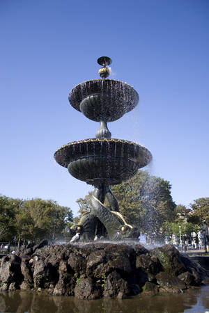 A water fountain against a sunny blue skyの写真素材