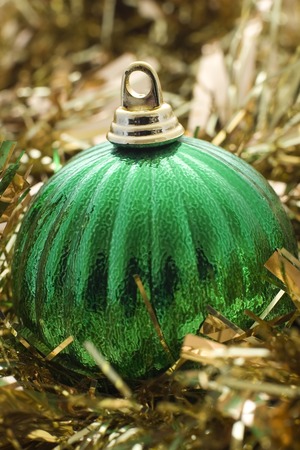 A green christmas decoration with gold tinselの写真素材