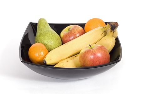 Fresh fruit in a black ceramic bowlの写真素材