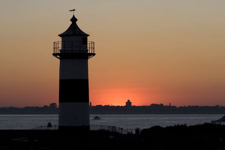 A silhouette of a lighthouse at duskの写真素材