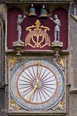 An old fashioned ornate clock with knights hitting the bellsの写真素材