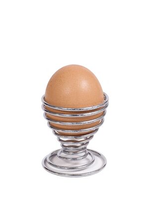 A brown hens egg in an eggcupの写真素材