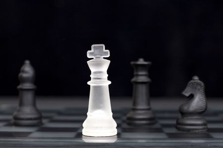 The white king comes under attack in a game of chessの写真素材
