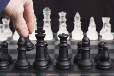 The first move in a game of chess, shallow depth of field focusing on players handの写真素材