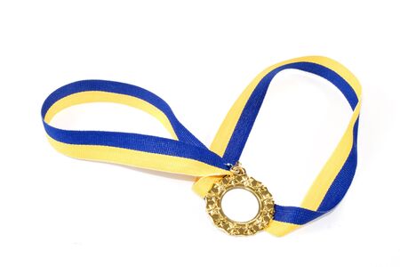 A gold medal on a yellow and blue ribbonの写真素材
