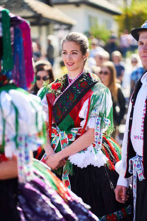 Portrait of a young woman dressed in a traditional folk costume in Holloko village, Hungary country