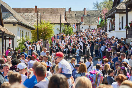 Group of women, dressed in a traditional folk costumes, among tourists during Easter celebration in Holloko village, Hungary countryのeditorial素材
