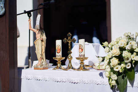 Figure of resurrected Jesus, cross and candles on an altar during Easter Holy Mass in Holloko village, Hungaryのeditorial素材
