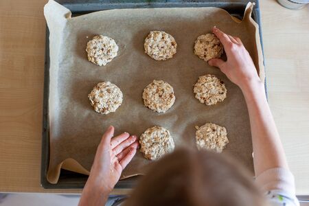 Tray of easy to prepare and healthy, home made oatmeal cookies - made by a little girl