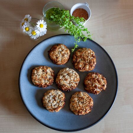 Blue plate of easy to prepare and healthy, home made oatmeal cookies - made by a little girl