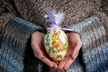 A girl is holding the Easter egg, decorated with decoupage â decoration for Easter holidayの写真素材