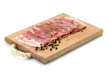 Meat slices with black pepper on white backgroundの写真素材