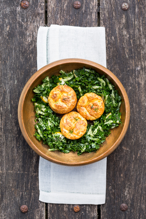 green cucumber salad and cheese pies in wooden bowlの写真素材