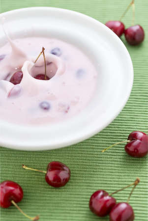 sweet cherry soup with fresh cherries on green tableclothの写真素材