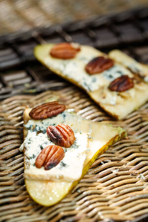 pear appetizer with blue cheese and pecan nutsの写真素材