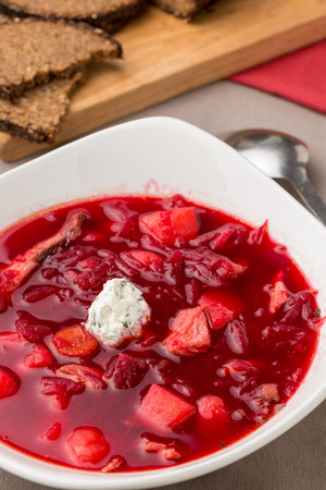 beet soup in white bowl with bread. Borsh. Vertical image.の写真素材
