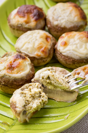 mushroom stuffed with cheese on green plate. Vertical image.の写真素材