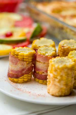 prepared corn pieces with bacon and cheese. Vertical image.の写真素材