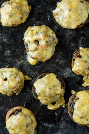 mushroom stuffed with cheese on cooking pan. Vertical image.の写真素材
