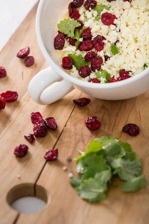 flower cabbage salad with parsley and cranberry in big cup. Vertical image.の写真素材