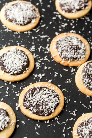 round cookies with chocolate topping and coconutの写真素材