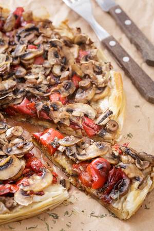 closeup of mushroom pizza with red sweet pepper on cooking paper. Vertical image.の写真素材