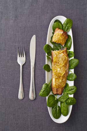 fried fish with squash decorated with basil on a grey backgroundの写真素材