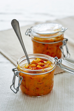 two jars of chutney on the white backgroundの写真素材