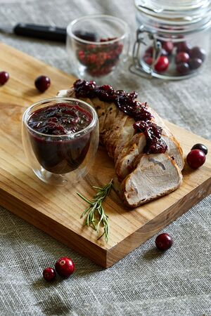 pork loin slices with cranberry jam in the grey backgroundの写真素材