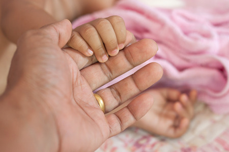 Child holding father's handの写真素材