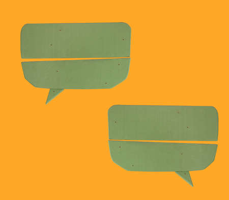 green wooden sign on yellow backgroundの写真素材