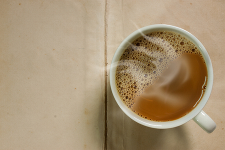 coffee mug on old paper backgroundの写真素材