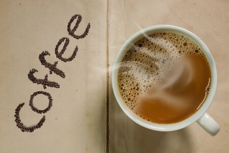coffee mug on old paper backgroundの写真素材