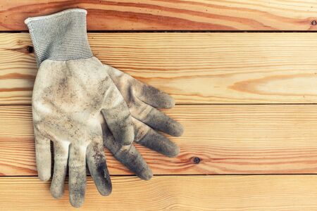 Gardening gloves on wood background