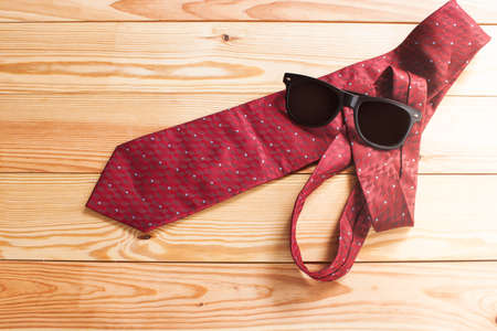 Glasses and Tie on wood backgroundの写真素材