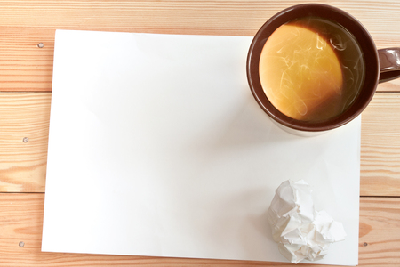 mug of coffee on a blank sheet of paperの写真素材