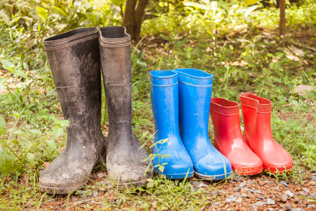 Rubber boots covered with mud in frontの写真素材