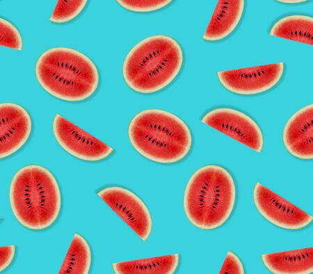 Watermelon pattern made of sliced watermelon on blue background. Flat lay, top view.