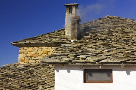 Old house with a smoky chimneyの写真素材