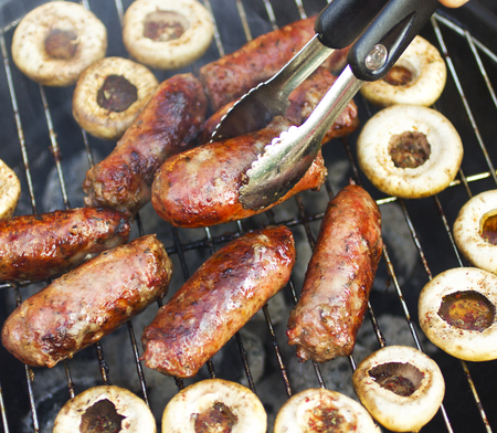 Grilled sausages, meatballs and mushroomsの写真素材