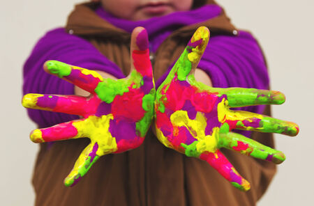 Child with colorful handsの写真素材