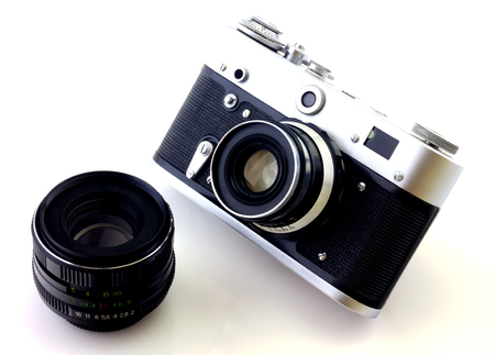 Retro camera and lens isolated on whiteの写真素材