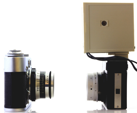 Retro cameras and flash isolated on whiteの写真素材