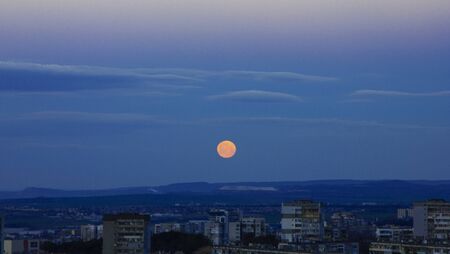 Full moon over cityの写真素材
