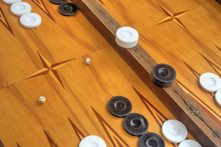 Wooden board for playing backgammon game with pools and dice